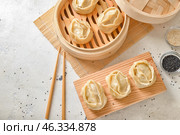 Steamer with oriental dumplings on white background. Стоковое фото, фотограф Pixel_shot / Фотобанк Лори