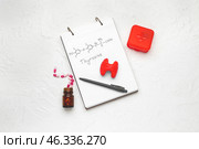 Notebook with chemical formula of thyroxine, model of thyroid gland and pills on white background. Стоковое фото, фотограф Pixel_shot / Фотобанк Лори