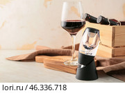 Aerator with glass and bottles of wine on table. Стоковое фото, фотограф Pixel_shot / Фотобанк Лори