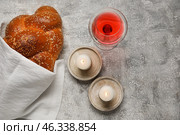 Traditional challah bread with glass of wine and candles on grunge background. Shabbat Shalom. Стоковое фото, фотограф Pixel_shot / Фотобанк Лори