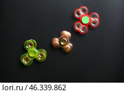 Stroboscopic photo of moving spinners on dark background. Стоковое фото, фотограф Pixel_shot / Фотобанк Лори