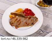Delicious mediterranian style steak served with baked tomatoes and onions. Стоковое фото, фотограф Яков Филимонов / Фотобанк Лори