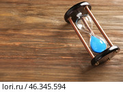 Hourglass on wooden table. Time management concept. Стоковое фото, фотограф Pixel_shot / Фотобанк Лори
