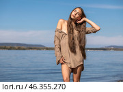 Portrait of a young brunette woman posing in beige tunic. Стоковое фото, фотограф Андрей Аркуша / Фотобанк Лори