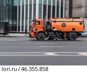 Orange street sweeper truck on city road in motion. Редакционное фото, фотограф Константин Григорьев / Фотобанк Лори