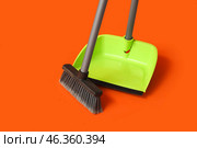 Plastic dustpan with cleaning broom on color background. Стоковое фото, фотограф Pixel_shot / Фотобанк Лори
