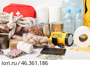Necessities for emergency bag on white table. Стоковое фото, фотограф Pixel_shot / Фотобанк Лори