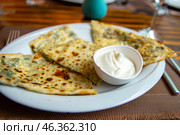Delicious gourmet flat bread kutabs with herbs and cheese on a plate. Стоковое фото, фотограф Евгений Ткачёв / Фотобанк Лори