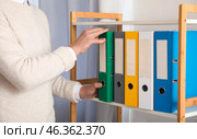 Young man working with documents in office. Стоковое фото, фотограф Pixel_shot / Фотобанк Лори