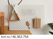 Pegboard with decor, rattle and books hanging on color wall in children's room. Стоковое фото, фотограф Pixel_shot / Фотобанк Лори