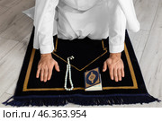 Praying young Muslim man at home. Стоковое фото, фотограф Pixel_shot / Фотобанк Лори