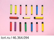 Different modern disposable electronic cigars on pink background. Стоковое фото, фотограф Pixel_shot / Фотобанк Лори