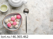Bowl of tangyuan, cup and teapot on grunge background. Dongzhi Festival. Стоковое фото, фотограф Pixel_shot / Фотобанк Лори
