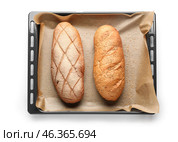 Baking sheet with loafs of fresh bread on white background. Стоковое фото, фотограф Pixel_shot / Фотобанк Лори