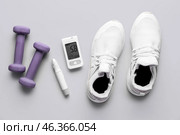 Glucometer, sneakers, lancet and dumbbells on grey background. Diabetes concept. Стоковое фото, фотограф Pixel_shot / Фотобанк Лори