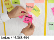 Man with sticker near scrum task board in office. Стоковое фото, фотограф Pixel_shot / Фотобанк Лори
