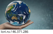 Holding the world in one hand is a powerful embodiment of unity and caring for the planet. Earth Day. Стоковое AI-видео, аниматор Оксана Медведева / Фотобанк Лори