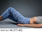 Young woman with anorexia on grey background. Стоковое фото, фотограф Pixel_shot / Фотобанк Лори
