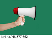 Hand of young woman with megaphone on color background. Стоковое фото, фотограф Pixel_shot / Фотобанк Лори