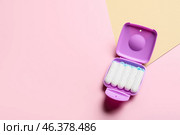 Tampons storage box on pink and beige background, top view. Стоковое фото, фотограф Pixel_shot / Фотобанк Лори