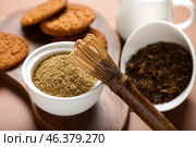 Wooden board with tasty hojicha cookies, powder and chasen on brown background. Стоковое фото, фотограф Pixel_shot / Фотобанк Лори