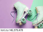 Roller skates with untied laces on color background, closeup. Стоковое фото, фотограф Pixel_shot / Фотобанк Лори