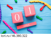 Calendar with date of April Fools Day and balloons on color wooden background. Стоковое фото, фотограф Pixel_shot / Фотобанк Лори