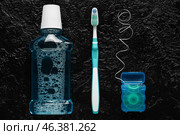 Dental floss with tooth brush and rinse on dark background. Стоковое фото, фотограф Pixel_shot / Фотобанк Лори
