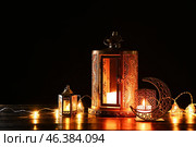Arabic candle holder with glowing fanoos lamps on dark background. Стоковое фото, фотограф Pixel_shot / Фотобанк Лори