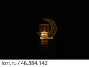 Arabic candle holder with glowing candle on dark background. Стоковое фото, фотограф Pixel_shot / Фотобанк Лори