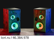 Modern loudspeakers on table against black background. Стоковое фото, фотограф Pixel_shot / Фотобанк Лори