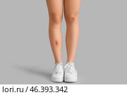 Young woman with bruised legs on grey background. Стоковое фото, фотограф Pixel_shot / Фотобанк Лори
