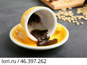 Cup with spent coffee grounds for fortune telling on table. Стоковое фото, фотограф Pixel_shot / Фотобанк Лори