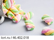 Overturned cup with tasty marshmallows on grey background. Стоковое фото, фотограф Pixel_shot / Фотобанк Лори