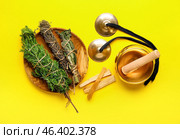 Tibetan singing bowl, karatalas, Palo Santo and herbs for aura cleansing on color background. Стоковое фото, фотограф Pixel_shot / Фотобанк Лори