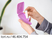 Young woman with tampon and box in bathroom, closeup. Стоковое фото, фотограф Pixel_shot / Фотобанк Лори
