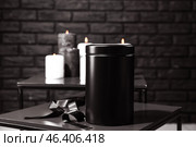 Mortuary urn with ribbon on table in room. Стоковое фото, фотограф Pixel_shot / Фотобанк Лори