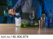 Barkeeper preparing Blue Lagoon cocktail at table in bar. Стоковое фото, фотограф Pixel_shot / Фотобанк Лори