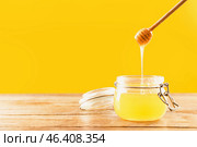Jar and dipper with tasty honey on color background. Стоковое фото, фотограф Pixel_shot / Фотобанк Лори