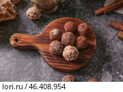 Wooden board with tasty sweet truffles on grey table. Стоковое фото, фотограф Pixel_shot / Фотобанк Лори