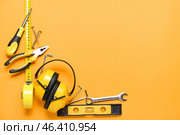 Frame made of builder's tools with hearing protectors on color background. Стоковое фото, фотограф Pixel_shot / Фотобанк Лори