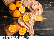 Squeezer with fresh oranges and juice on dark table. Стоковое фото, фотограф Pixel_shot / Фотобанк Лори