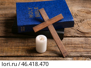 Christian cross, Bibles and candle on wooden background. Стоковое фото, фотограф Pixel_shot / Фотобанк Лори