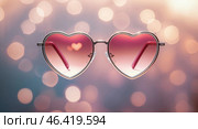Heart-shaped sunglasses reflecting shimmering light create a romantic atmosphere for summer outings and celebrations. Стоковое AI-изображение, AI-художник Сергей Толмачёв / Фотобанк Лори