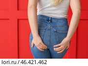 Young woman on color background. Hemorrhoids concept. Стоковое фото, фотограф Pixel_shot / Фотобанк Лори