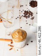 Glass of tasty dalgona coffee on table. Стоковое фото, фотограф Pixel_shot / Фотобанк Лори