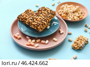 Crispy rice bars on color background. Стоковое фото, фотограф Pixel_shot / Фотобанк Лори