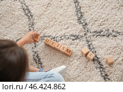 Little girl with autistic disorder playing with cubes at home. Стоковое фото, фотограф Pixel_shot / Фотобанк Лори