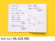 Copybook with maths formulas on yellow background. Стоковое фото, фотограф Pixel_shot / Фотобанк Лори
