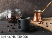 Cup of delicious espresso, coffee beans and jezve on table. Стоковое фото, фотограф Pixel_shot / Фотобанк Лори
